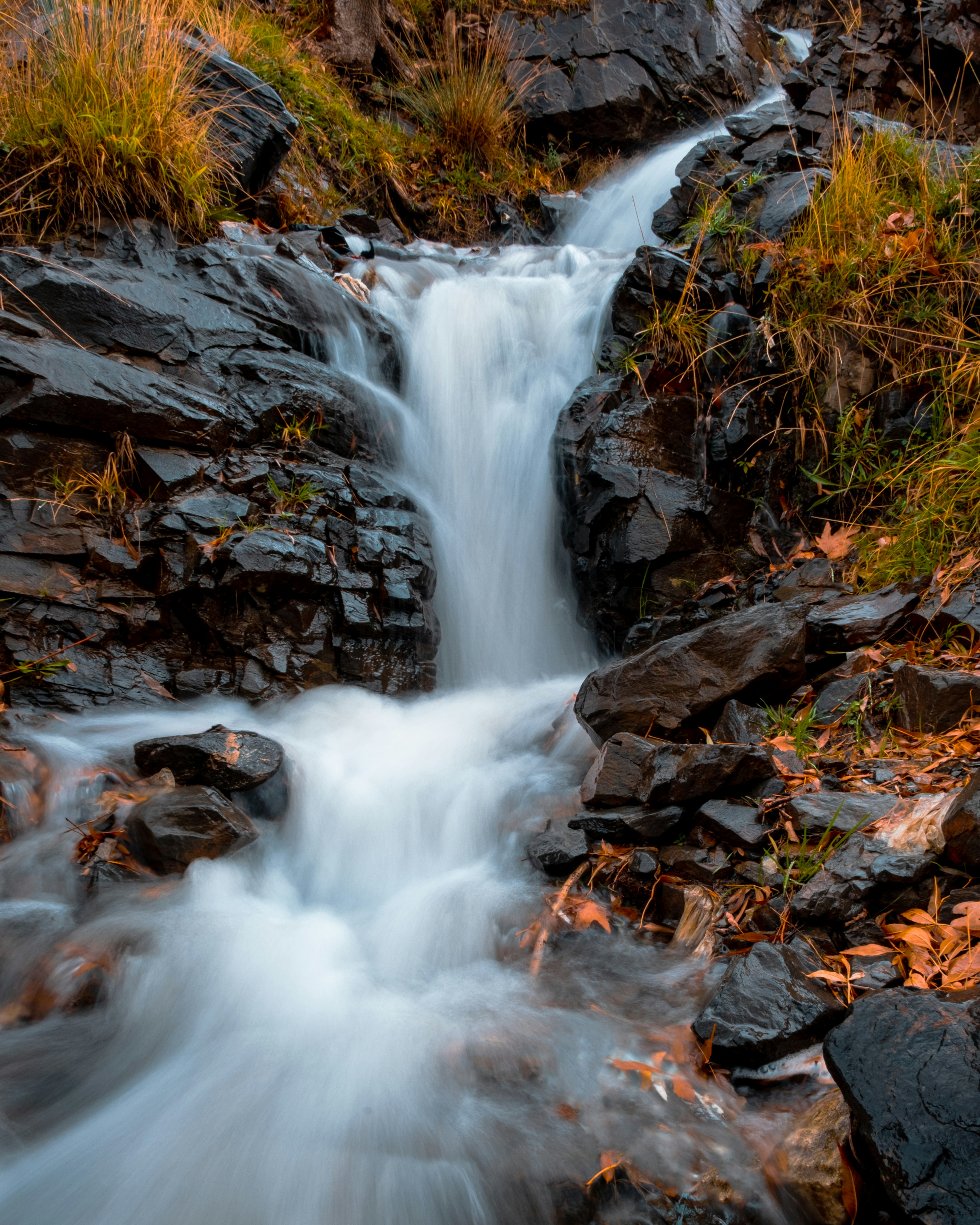 water falls on brown rocky ground